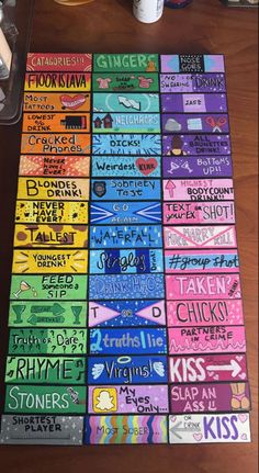 a table topped with lots of different colored stickers on top of a wooden table