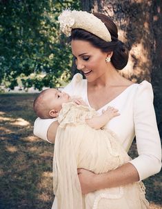 a woman holding a baby in her arms