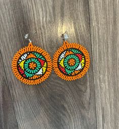 These gorgeous traditional beaded Zulu disc earrings are a gorgeous statement piece must haves.  Please note each piece is handmade and slight variations may occur. Artisan Multicolor Round Beaded Earrings, Traditional Beaded Hoop Earrings, Artisan Orange Beaded Earrings, Artisan Orange Round Bead Earrings, Traditional Round Bead Earrings For Festivals, Traditional Beaded Earrings With Round Beads, Beaded Round Earrings For Festival, Traditional Round Beaded Earrings With Large Beads, Handmade Earrings With Round Beads For Festivals