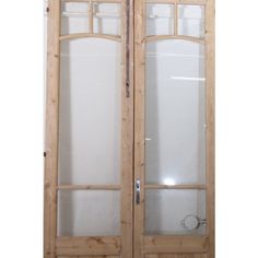 an open wooden door with frosted glass on the front and side panels in between