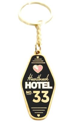 a keychain with the words hotel 33 on it's front and back