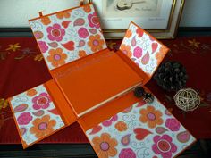 an assortment of orange and pink paper with flowers on them