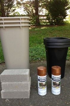 three cans and two trash cans sitting next to each other on the ground in front of a garbage can