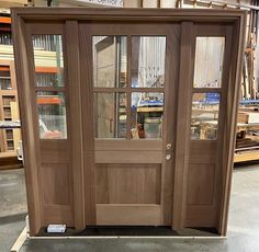 an open wooden door in a warehouse with shelves and other items behind the glass doors