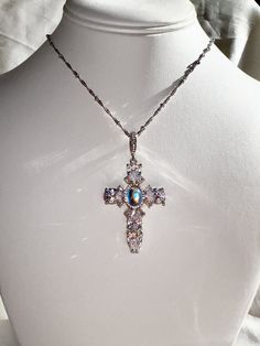 Dolce Diamond CZ Cross Necklace with Chain with 14k White Gold or 14k Yellow Gold option. Center stone is Rainbow moonstone surrounded by cubic zirconia diamond stones.  Perfect Bling statement piece. Satellite Chain with custom length between 16-17.5 in.  High Quality Gold Filled, not cheaper Gold Plated.  Gold-filled jewelry offers greater durability, thicker gold layer, and longevity.  Less prone to chipping and tarnishing like the other cheaper gold alternatives. I'm happy to assist! Please Diamond White Crystal Cross Pendant Jewelry, Fine Jewelry Cross Pendant For Wedding, Fine Cross Pendant Jewelry For Weddings, Elegant Cross-shaped Jewelry, White Gold Crystal Cross Pendant Necklace, Wedding Jewelry: Cubic Zirconia Cross Pendant, Cubic Zirconia Cross Pendant Jewelry For Weddings, Cubic Zirconia Cross Pendant For Wedding, Crystal Jewelry With Diamond Accents, Cross Pendant