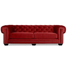 a red couch sitting on top of a white floor