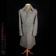 Gents vintage tweed overcoat from Kindler label. Grey weave pure wool tweed cloth tailored with a raglan sleeve and a belt at the waist. Fantastic vintage garment. Best fits gent's 44-46" chest (a Raglan sleeve is designed to be roomier so that a tweed jacket or a jumper can be worn underneath so it is likely designed for 44", but will fit up to 46") * Underarm to underarm 24" * Shoulder to hem 44" * Underarm to cuff 17" Retro Tweed Outerwear With Notch Lapel, Vintage Tweed Jacket With Lapel Collar For Winter, Vintage Herringbone Outerwear For Work, Retro Tailored Tweed Outerwear, Tailored Retro Tweed Outerwear, Vintage Tweed Jacket For Business In Winter, Retro Tweed Single-breasted Outerwear, Fitted Vintage Tweed Outerwear, Vintage Wool Outerwear With Herringbone Pattern