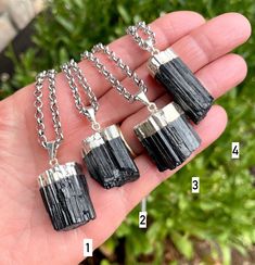 "We have a beautiful selection of raw Black Tourmaline Pendant Necklaces in various silver chain lengths.  This is the ultimate protection and grounding natural stone, and perfect for layering or worn alone.   The raw pendants are dipped in silver and attached to electroplated silver rolo chain.  Chain lengths vary from 16\" to 20\".  Choose your favorite necklace: #1 - Chain 16\", Pendant 1\" #2 - Chain 16\", Pendant .9\" #3 - Chain 18\", Pendant .8\" #4 - Chain 18\", Pendant 1.2\" #5 - Chain 1 Black Gemstone Crystal Necklace For Spiritual Use, Spiritual Black Gemstone Crystal Necklace, Spiritual Black Necklace With Raw Stone, Black Tourmaline Pendant, Black Tourmaline Necklace, Tourmaline Pendant, Rolo Chain, Black Tourmaline, Star Necklace