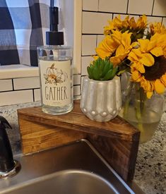 sunflowers are sitting in vases next to a sink