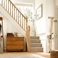 a wooden dresser sitting next to a stair case