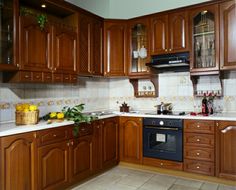 a kitchen with wooden cabinets and white counter tops