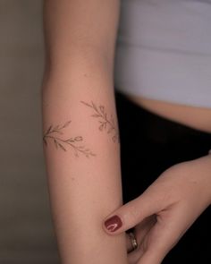 a woman's hand with a small tattoo on her left arm and the wrist