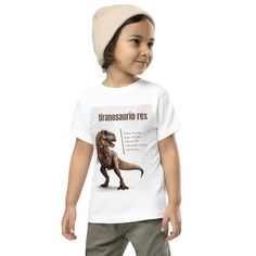 Get ready for ROAR-some fun with our tiranosaurio rex shirt for kids! This cool and colorful shirt features a fierce T-Rex design that is sure to make your little one the star of the playground. Made from soft, comfortable material, this shirt is perfect for everyday wear. Whether your child is a dinosaur enthusiast or just loves a cool graphic, this shirt is sure to be a hit. Buy now and watch your child's imagination come to life! The tee is soft, durable, and bound to become the staple of your toddler's wardrobe.  * 100% combed and ring-spun cotton * Relaxed fit for extra comfort * Pre-shrunk fabric This product is made especially for you as soon as you place an order, which is why it takes us a bit longer to deliver it to you. Making products on demand instead of in bulk helps reduce o Casual Fitted Top With Dinosaur Print, Fitted Casual Top With Dinosaur Print, Fitted Cotton Tops With Dinosaur Print, Fitted Short Sleeve Tops With Dinosaur Print, Casual Fitted Dinosaur Print Top, Fitted Short Sleeve Dinosaur Print Top, Funny Cotton Top With Dinosaur Print, Green Dinosaur Print T-shirt For Birthday, Fun Summer T-shirt With Dinosaur Print