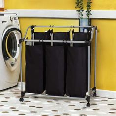 a laundry basket with three bags on it next to a washing machine