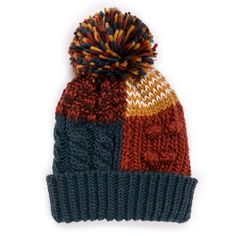 a multicolored knitted hat with a pom