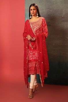 Red kurta with bandhani woven motifs and gota embroidered neckline. Paired with embroidered dupatta.
Components: 2
Pattern: Woven, Embroidery
Type Of Work: Bandhani, gota
Neckline: U neck
Sleeve Type: Three quarter
Fabric: Silk
Color: Red
Other Details: 
Cutwork border
Attached lining
Kurta Length: 47 inches
Note: Pant worn by the model is not for sale
Occasion: Sangeet - Aza Fashions Luxury Red Bandhani Print Salwar Kameez, Festive Bandhani Print Straight Kurta Anarkali Set, Red Chanderi Unstitched Suit With Dabka Work, Festive Straight Kurta Churidar With Bandhani Print, Unstitched Bandhani Print Anarkali Set For Festive Season, Unstitched Bandhani Print Anarkali Set For Festive Occasions, Festive Semi-stitched Churidar With Bandhani Print, Mulmul Churidar With Bandhani Print Straight Kurta, Straight Kurta Churidar In Bandhani Print And Mulmul