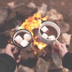 two people toasting marshmallows over a campfire with the words good morning