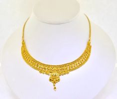 22k Gold 15" Ornate Handmade Necklace. 20.8grams Add a touch of elegance to your outfit with this stunning 22k gold necklace. Crafted by hand, this necklace features an ornate design that is sure to catch the eye. The necklace is 15 inches in length and made with yellow gold, giving it a luxurious look. The necklace is perfect for any occasion and would make a great addition to any jewelry collection. The Estate brand is known for its high-quality jewelry, and this necklace is no exception. Whether you're looking for a special gift or just want to treat yourself, this necklace is sure to impress. The necklace has a solid weight of 20.8grams.  We are a small family owned business located in Massapequa, N.Y. Customer satisfaction is our number one goal, and we will do everything we can to en 15 Grams Gold Necklace Design, 8 Grams Gold Necklace, 22k Gold Necklace, Lana Jewelry, Ornate Design, Gold Necklace Designs, Small Family, Fine Jewellery Necklace, Handmade Necklace