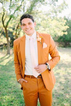 a man in an orange suit and white shirt