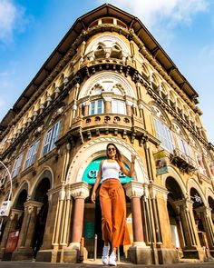 a woman standing in front of an old building