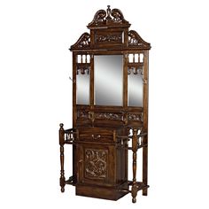 an ornate wooden cabinet with mirror on top