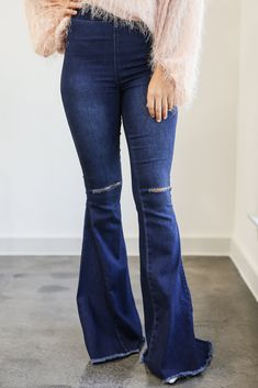 Stay groovy with "The Logan" pants featuring a high waist, a light wash color, oversized flared bottoms, a stretchy fit, an elastic waistband, frayed hems, and distressed knees! These retro bottoms will take you from season to season when you wear your favorite open-toed heel and tank top in the summer and with booties and a sweater in the fall! 65% Cotton 33% Polyester 2% Spandex Model is a US size Small. - Height: 5'5" - Bust: 34" - Waist: 26.5" - Hips: 35" Trendy Fitted Distressed Flares, Stretch Flare Pants With Frayed Hem, Trendy Fall Flare Jeans With Frayed Hem, Stretch Ripped Flare Jeans In Denim Blue, Distressed Flare Jeans For Summer, Stretch Ripped Denim Blue Flare Jeans, High Waist Stretch Flares With Frayed Hem, Summer Distressed Flare Jeans, Ripped Stretch Flare Jeans