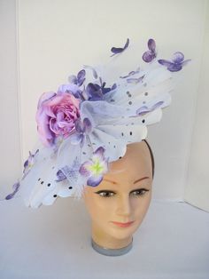 "* This pleated polka dot hat base has a 14\" diameter and has an overlay of shredded white horsehair with purple Hydrangea petals scattered about. In the center are two pink silk roses with purple highlights. * On a satin covered acrylic headband it is secure, well balanced and comfortable to wear for extended periods of time. * Upon ordering you will receive this exact headpiece. * Perfect for this Season's Derby events, ladies luncheon and gatherings, fashion show, wedding, wedding shower or Acrylic Headband, Hydrangea Petals, Tiki Dress, White Fan, Purple Hydrangea, Ladies Luncheon, Purple Highlights, Hat Base, Hydrangea Purple