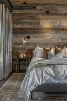 a bedroom with wood paneled walls and white bedding