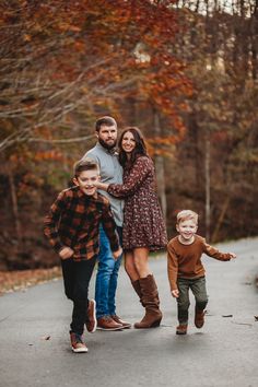 a family walking down a road in the fall