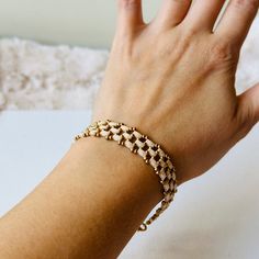 Add vintage notes to your everyday look using this dainty beaded bracelet. It is made from Miyuki Tila beads, Czech seed beads and supplied with gold-toned accessories. This elegant flat bead bracelet will always accessorise you with a perfect touch of understated luxury and style. You can wear this tile cuff bracelet anywhere, anytime, whether it's during the day with jeans or with a little black dress for a glamorous event.  If you're looking for statement seed bead bracelet or jewelry in bohe Dainty Adjustable Gold Beaded Bracelets, Delicate Adjustable Jubilee Chain Bracelet, Minimalist Adjustable Chain Bracelet With Gold Beads, Minimalist Adjustable Gold Beads Chain Bracelet, Minimalist Adjustable Gold Beaded Chain Bracelet, Elegant Beaded Chain Bracelet For Everyday, Elegant Gold Stretch Bracelet With Tiny Beads, Elegant Everyday Beaded Chain Bracelet, Handmade Dainty Gold Pearl Bracelet