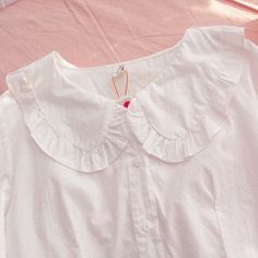 Kawaii Lolita White Shirt with Bunny Ears Peter Pan Collar and 7/8 sleeves, buttons through front. One Size Shoulders: 41cm/16" Bust: 100cm/39.5" Length: 56cm/22" Sleeve: 53cm/21" Material: COTTON, Polyester Cute White Blouse With Lace Collar, Spring Blouse With Cute Collar, Cute White Blouse With Doll Collar, Cute Long Sleeve Blouse For School, White Blouse With Doll Collar In Cute Style, Kawaii Style Blouse For Spring, Kawaii Long Sleeve Blouse, Cute Collared White Blouse, Cute White Collared Blouse