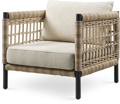 the chair is made out of wicker and has a beige cushion