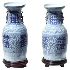 two blue and white vases sitting next to each other