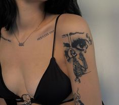 a woman with tattoos on her arm and chest