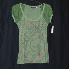 Very Cute Short Sleeve Paisley Print Tee Shirt/Top. Has A Different Shade Of Green With Different Print On The Sleeves. New With Tags. It Has Just Been In My Closet For A Long Time And Needs A New Home. Comes From A Smoke-Free Home With Dogs. Thanks For Looking In My Closet! Casual Patterned Spring T-shirt, Casual Fitted Floral Print T-shirt, Casual Green Printed Tops, Fitted Floral Print Casual T-shirt, Fitted Floral Print Scoop Neck Tops, Stretch Green Printed Top, Casual Short Sleeve Top With Floral Print, Stretch Green Printed T-shirt, Casual Cotton Patterned Tops