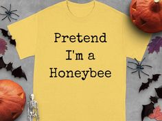 a t - shirt that says pretend i'm a honeybee next to pumpkins