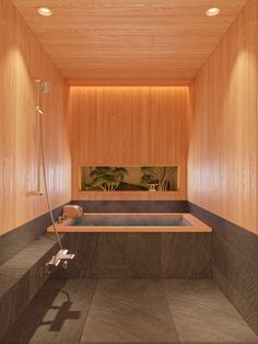 a bathroom with wooden walls and flooring has a large jacuzzi tub in the middle