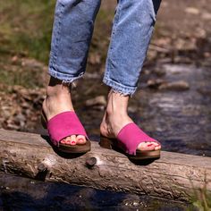 Step into vibrant style with our Flat Heel Clogs for Women, crafted from high-quality fuchsia suede leather. These clogs are a burst of color that adds an exciting touch to any summer outfit, making them an essential addition to your seasonal wardrobe.  Designed with both average and wide foot builds in mind, these clogs are the epitome of comfort and durability. They feature a linden wood insole that offers breathability and a pleasing underfoot feel, while the fuchsia suede leather exterior pr Summer Pink Clogs With Cushioned Footbed, Pink Summer Clogs With Cushioned Footbed, Pink Clogs With Cushioned Footbed For Spring, Purple Closed Toe Clogs For Summer, Summer Purple Closed Toe Clogs, Pink Leather Mules With Block Heel, Pink Sandals With Wooden Heel For Spring, Casual Pink Sandals With Stacked Heel, Pink Mules With Wooden Heel For Spring