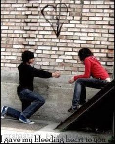 two young men sitting on the steps with their hands in each other's pockets