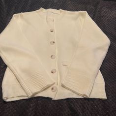 Cream Cardigan New Never Worn. Size S Front Pockets Classic Cream Cardigan With Buttons, Everyday Cozy Cardigan With Buttons, Cream Sweater With Button Closure For Work, Cozy Everyday Cardigan With Buttons, Classic Cream Cardigan With Button Closure, Classic Cream Cardigan For Everyday, Cream Everyday Sweater With Buttons, Cream Buttoned Everyday Sweater, Cream Cardigan With Buttons For Everyday