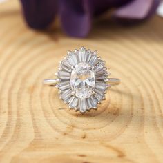 a diamond ring sitting on top of a wooden table