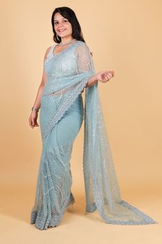 Indulge in luxurious elegance with our Net designer saree in stunning blue color. Adorned with delicate thread embroidery and sparkling sequin work, this saree exudes sophistication and exclusivity. Elevate your style and make a statement with our designer saree, perfect for any occasion. Net designer saree with thread embroidery and sequin work - blue color Saree comes with a blouse piece. Fall and pico done. Fully stitched blouse shown in pictures is optional and can be purchased seperately from our blouses and croptops section. For saree video please connect with us on whatsapp @469-937-0606 Ready to be shipped in USA from San Diego, California. All pictures are original pictures. Colors may slightly vary due to pic resolution. Designer Blue Pre-draped Saree With Mirror Work, Designer Blue Sequined Sharara, Festive Blue Pre-draped Saree With Sequins, Blue Sequined Pre-draped Saree For Party, Festive Blue Wedding Pre-draped Saree, Blue Zari Work Party Wear Pre-draped Saree, Blue Pre-draped Saree With Mirror Work For Party Wear, Festive Blue Georgette Pre-draped Saree, Traditional Blue Pre-draped Saree With Sequins