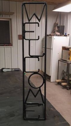 a large metal object in a garage next to a refrigerator