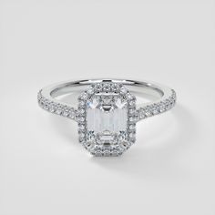 an engagement ring with a cushion cut diamond surrounded by pave diamonds