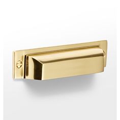 a gold door handle on a white wall