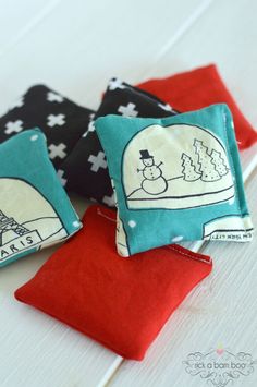 three small pillows are sitting on top of each other, one has an image of the eiffel tower