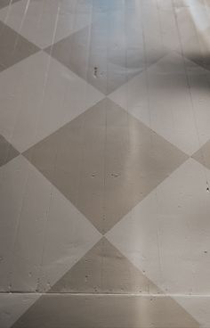 a black and white checkered floor with a clock on it