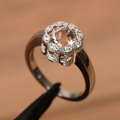 It is natural morganite ring, the main stone is about 7mm*7mm, round cut, weight about 1.3 carats.The basic metal is sterling silver and plated with rhodium.To change the metal to a solid gold (white/rose) or platinum is also available, please ask for a quotation if you want.You can also go to my shop Home for more elegant rings: https://www.etsy.com/shop/godjewelry?ref=hdr_shop_menuMore natural morganite rings:https://www.etsy.com/shop/godjewelry?ref=seller-platform-mcnav&section_id=1598143 Elegant Morganite Diamond Ring With Gemstone, Elegant Morganite Diamond Ring With Prong Setting, Luxury Round Morganite Rings, Luxury Morganite Round Ring, Classic Morganite Diamond Ring With Round Cut, Elegant Morganite Wedding Ring With Brilliant Cut, Elegant Topaz Ring With Morganite In Prong Setting, Morganite Diamond Ring With Brilliant Cut, Elegant Morganite Diamond Ring With Round Cut