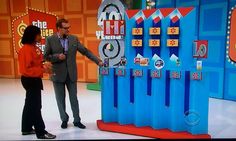 a man and woman standing in front of an interactive game on the set of tv talk show