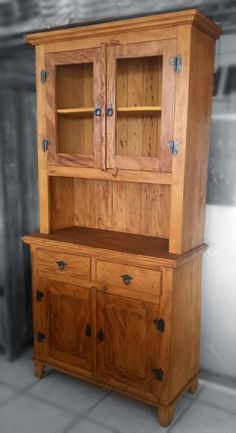 a wooden cabinet with two doors and drawers